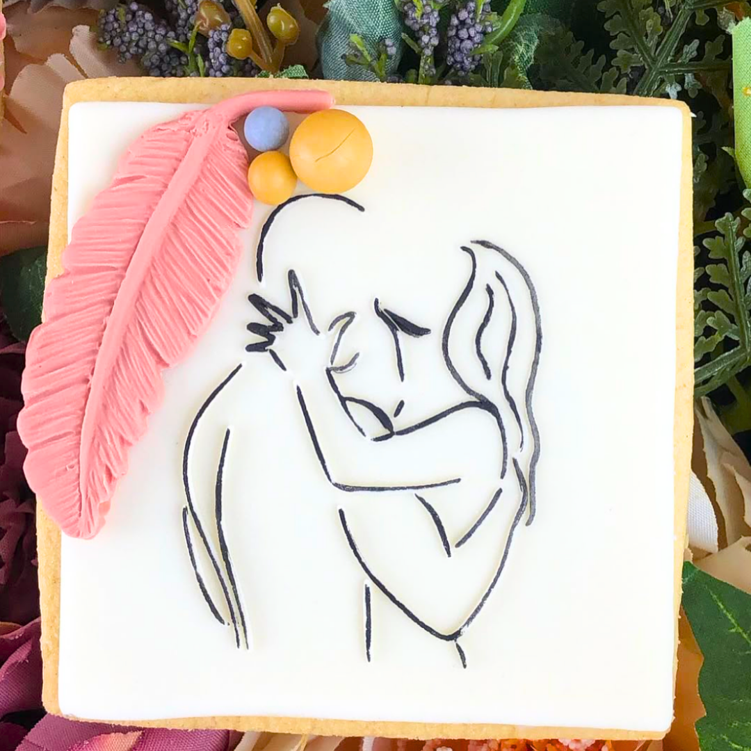 Decorative cookie with a stylized illustration of a couple and decorative elements on a floral background