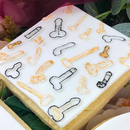 Decorative cookie with black and gold designs on a white background
