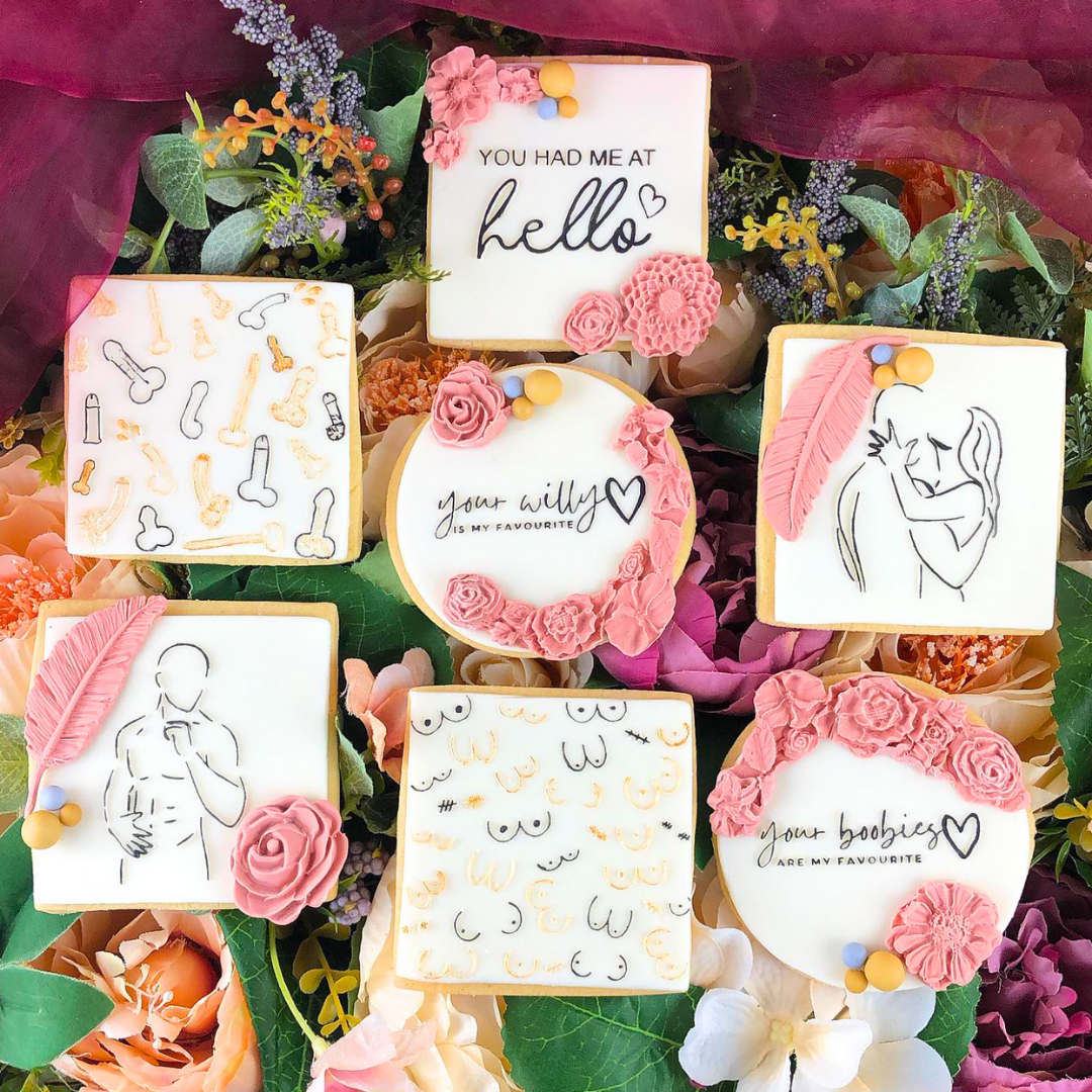 Decorative cookies with artistic designs and text on a floral background