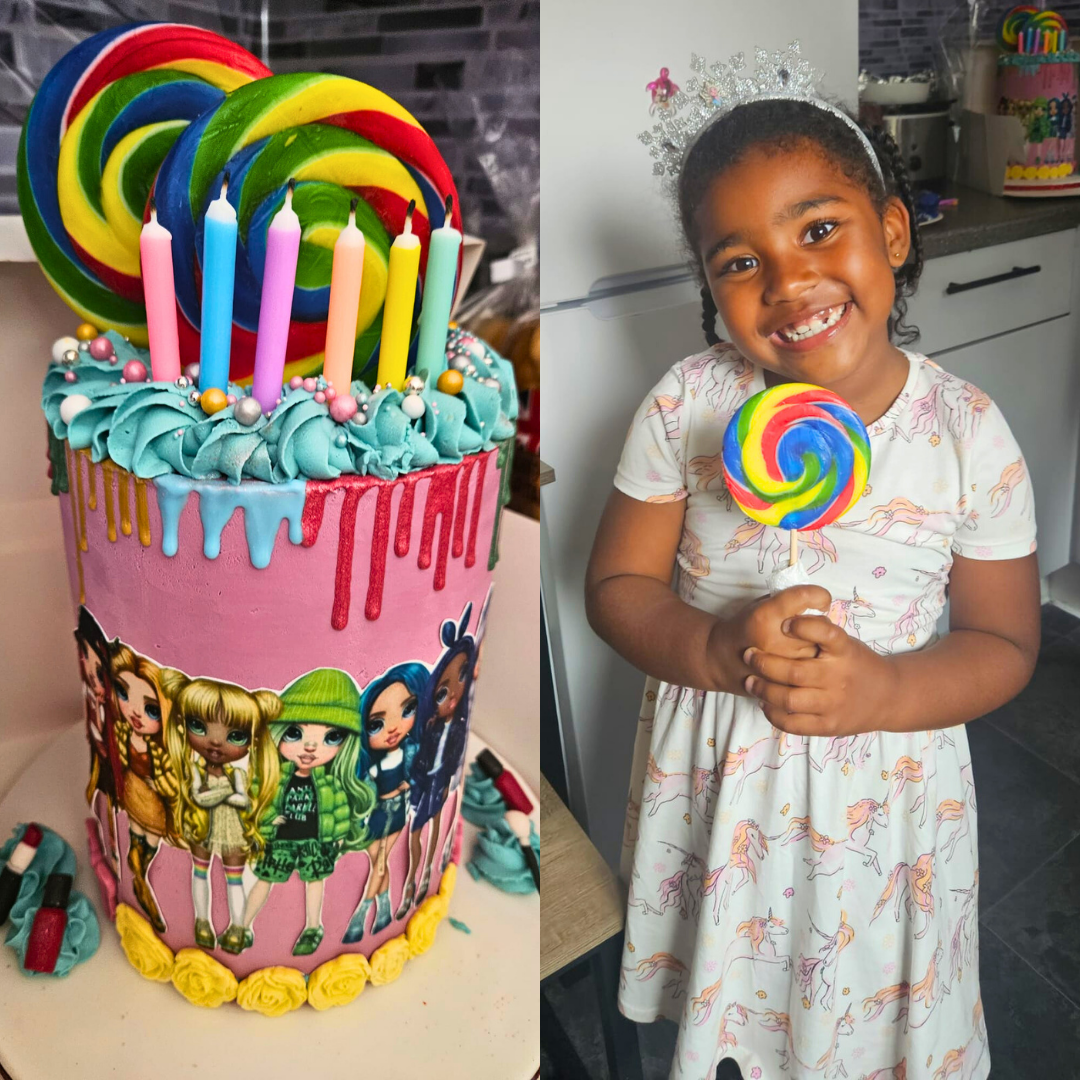 Colorful birthday cake with candles and a child holding a lollipop in a kitchen setting